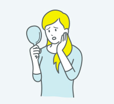 鏡を見て歯を気にしているイラストイメージ